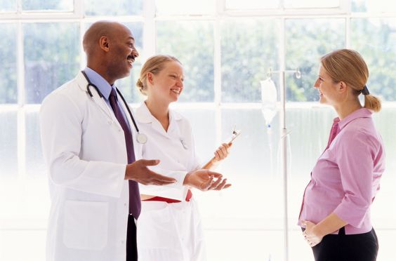 2 Physicians Talking to Pregnant Patient