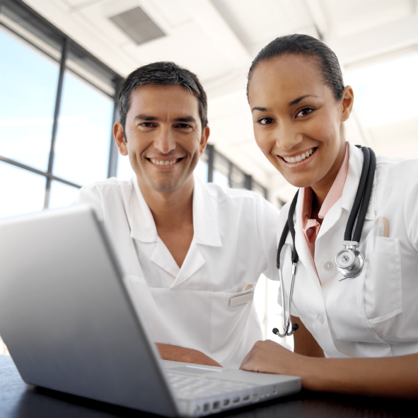 Tow Physicians Sitting at  a Laptop Computer