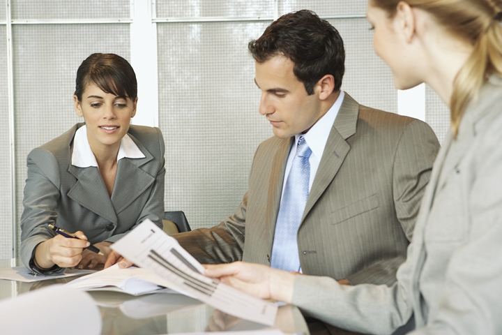 Medical malpractice insurance agents working at conference table