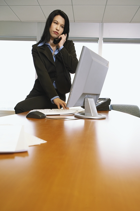 Woman on phone and laptop computer