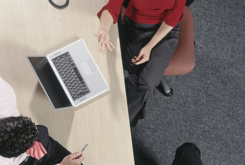 Physician Talking with Med Mal Insurance Agent Over Computer