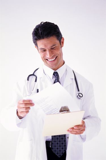 Happy Male Physician Looking at Chart
