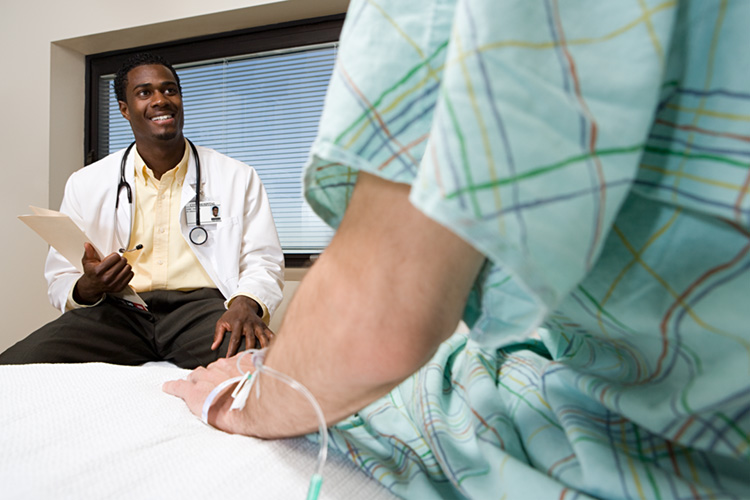 Physician talking to patient in bed