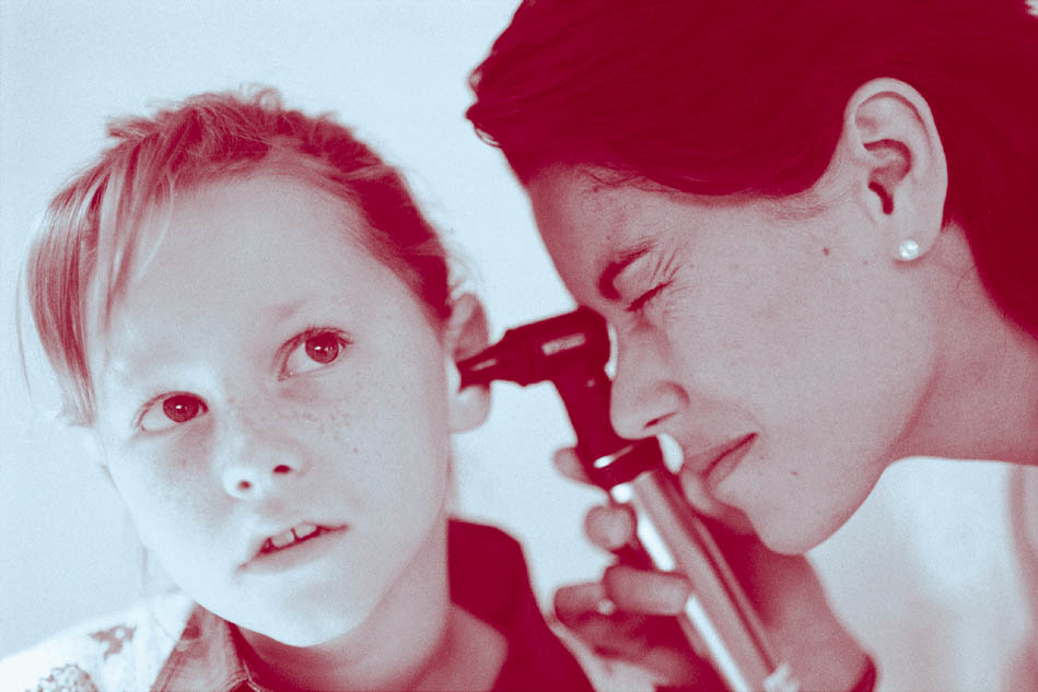 nurse looking in child's ear