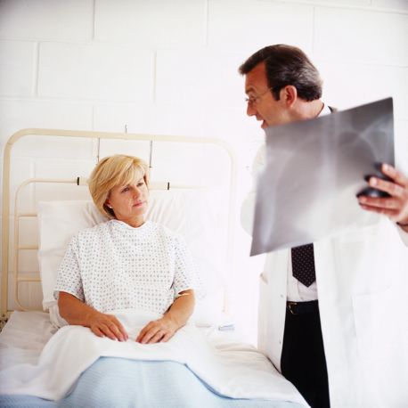 Physician Talking to Patient in Bed